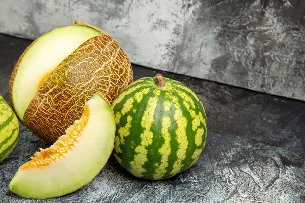 Front view fresh melon with watermelon on a dark-light background