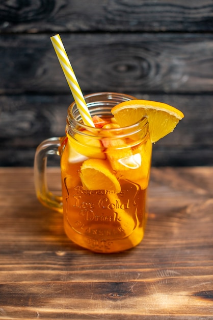 Front view fresh orange juice inside can on brown wooden desk drink photo cocktail color fruit bar