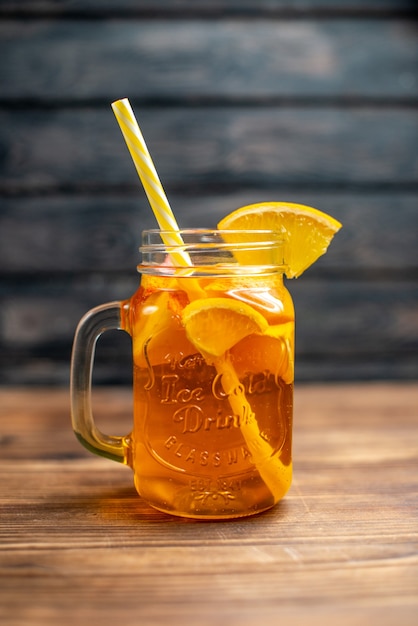 Front view fresh orange juice inside can with straw on wooden desk bar fruit color photo cocktail drink