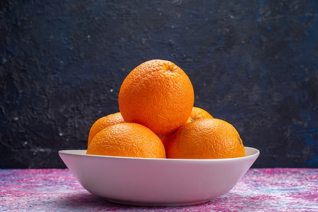 Front view fresh oranges inside white plate on dark