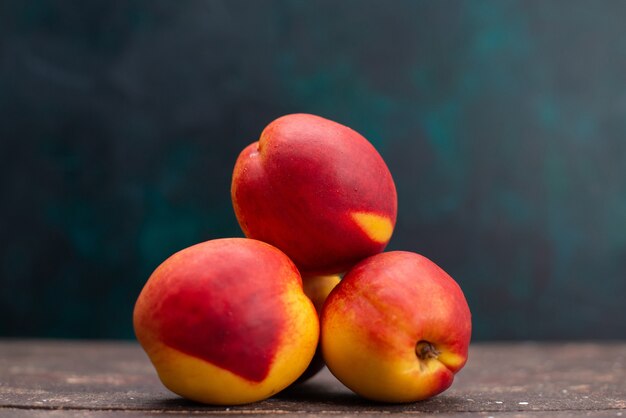 Front view fresh peaches delicious sweet fruits on dark-blue surface fruit drink juice mellow fresh