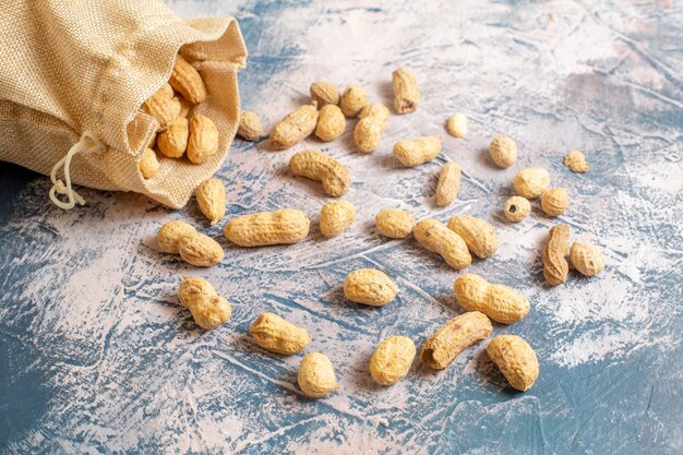 Front view of fresh peanuts on light surface