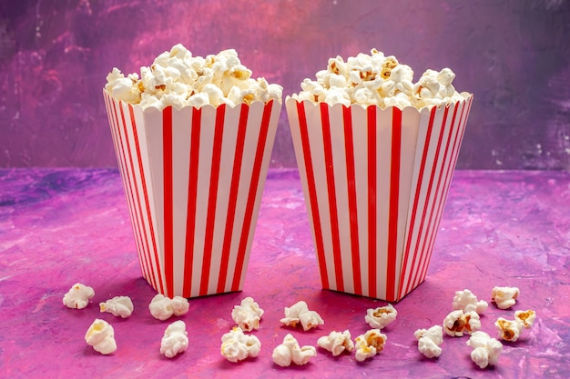 Front view fresh popcorn on light pink table color cinema movie