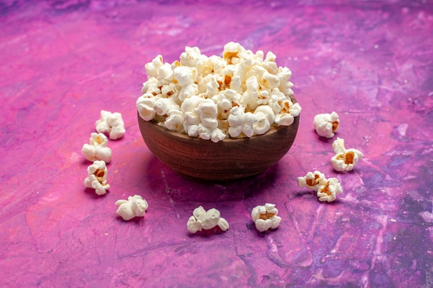 Front view fresh popcorn on pink table corn movie cinema