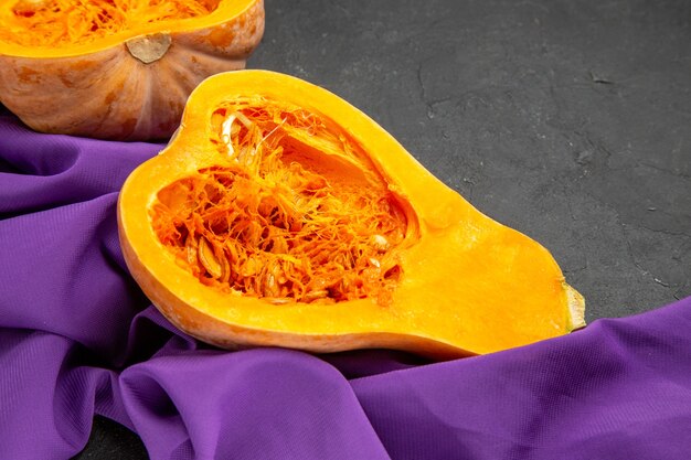 Front view fresh pumpkin half cut on a dark table food ripe color