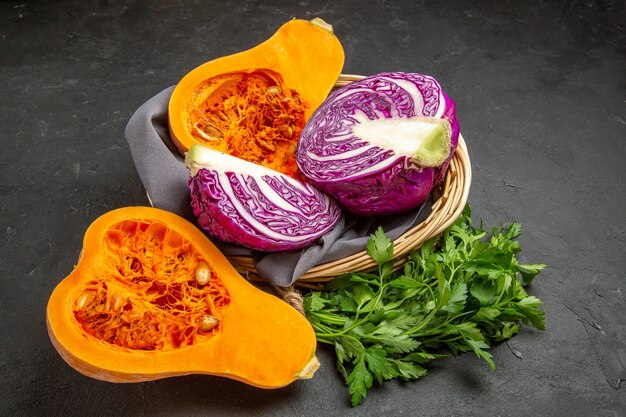 Front view fresh pumpkin with greens and red cabbage on dark table