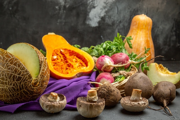 Front view fresh pumpkin with radish and greens on dark table ripe color food