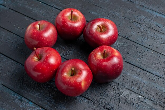 Front view fresh red apples mellow and ripe fruits on dark-blue desk fruit whole color red plant vitamine fresh