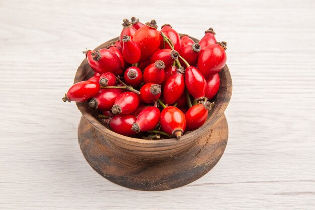 白い背景の上の小さなプレート内の新鮮な赤いベリーの正面図健康ベリー野生色の果物の写真