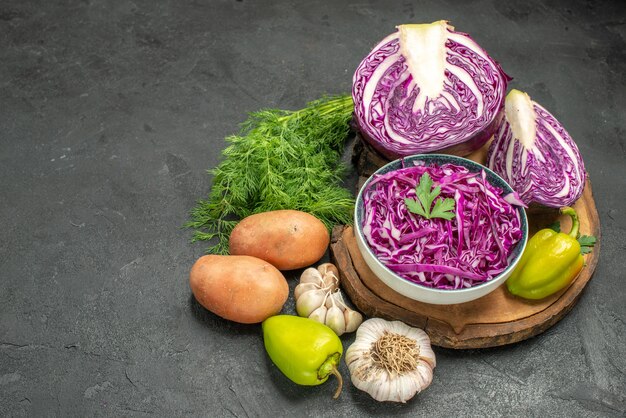 Front view fresh red cabbage with vegetables and greens on dark table salad diet ripe health