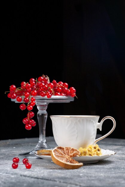 Front view fresh red cranberries with cup of coffee on the light desk fruit berry coffee lemon