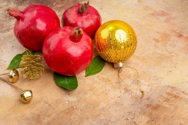 Free photo front view fresh red pomegranates on light background color photo mellow juice fruit xmas