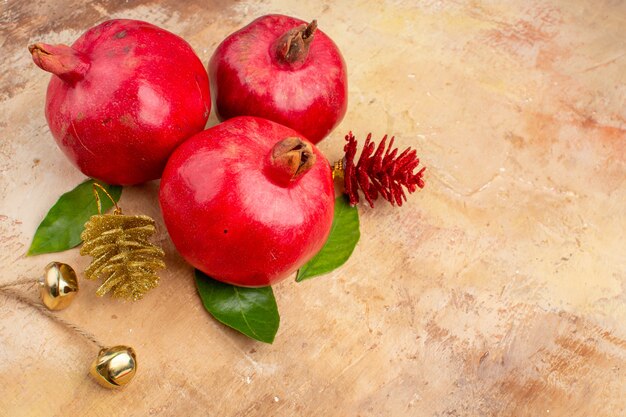 Front view fresh red pomegranates on a light background color photo mellow juice fruit