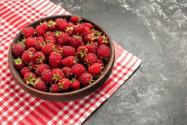 Front view fresh red raspberries inside plate on grey fruits color cranberry wild photo berry