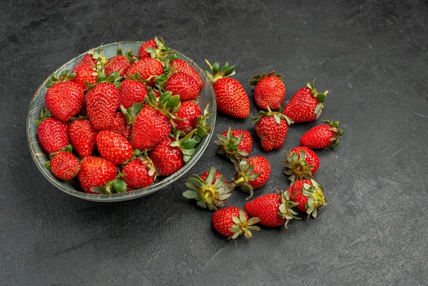 Front view fresh red strawberries inside plate and on grey background berry tree juice color  summer