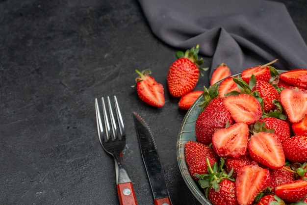 Front view fresh red strawberries inside plate with cutlery on dark background color wild berry summer juice  tree