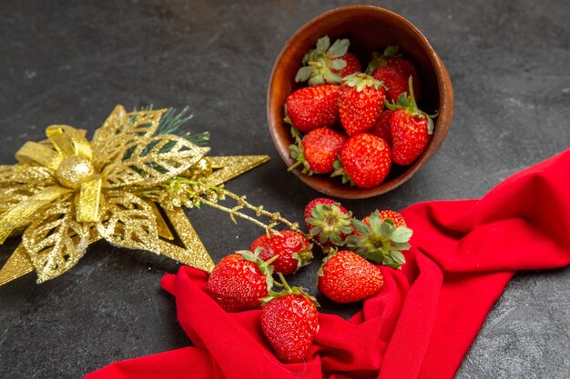 Front view fresh red strawberries inside plate with toy on dark background photo color many fruit mellow