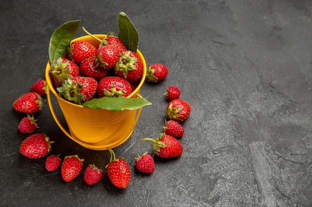 Front view fresh red strawberries lined on dark background