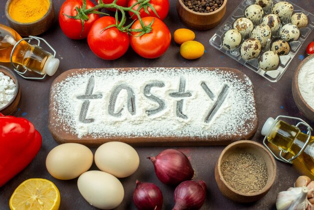 Front view fresh red tomatoes with eggs seasonings and flour on dark background vegetable salad food pepper snack diet milk