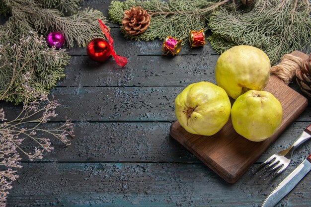 Front view fresh ripe quinces sour fruits on dark-blue rustic desk many fresh plant ripe fruit tree
