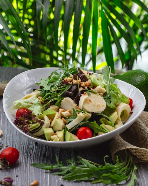 Free photo front view fresh salad with arugula avocado and tomato