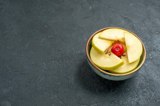 Front view fresh sliced apples inside little pot on grey background fresh fruits mellow ripe