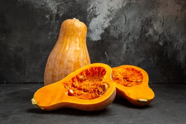 Front view fresh sliced pumpkins on dark table color fruit photo