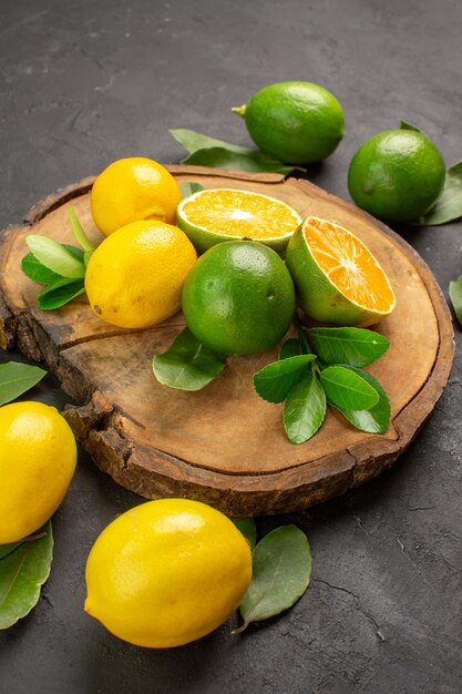 Front view fresh sour lemons on dark background