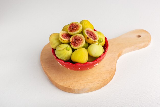 Front view fresh sweet figs delicious fetuses inside red plate on white desk