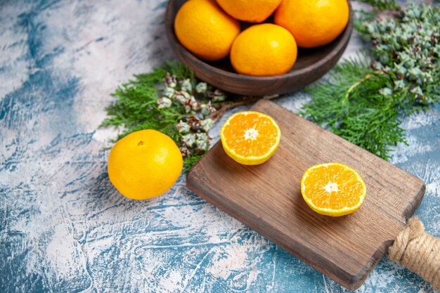 Front view fresh tangerine slices on light-blue table