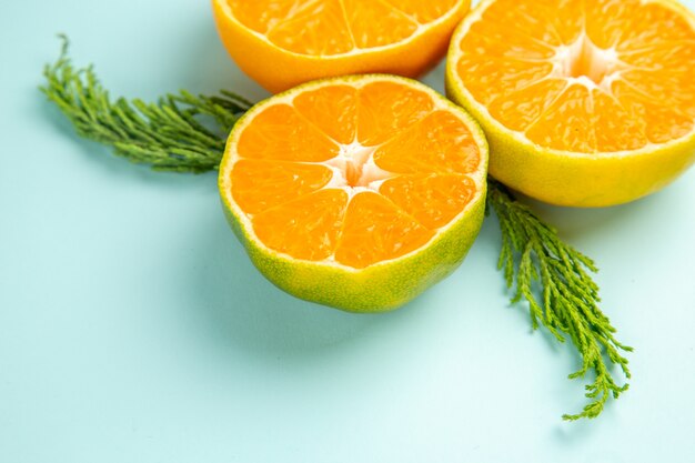 Front view fresh tangerine slices on light-blue table