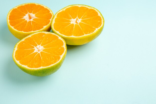 Front view fresh tangerine slices on the light-blue table