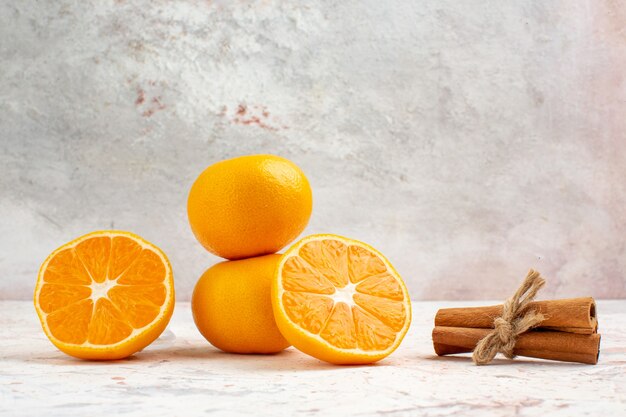 Front view fresh tangerines cinnamon sticks on bright background free space