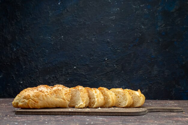 Front view fresh tasty pastry long bun formed cut pastry on brown wooden desk