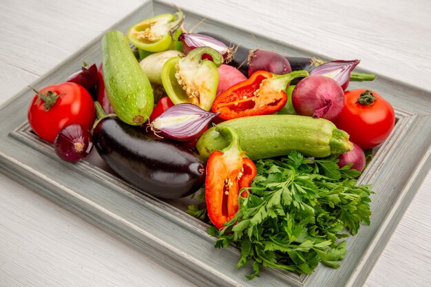 Front view fresh vegetable composition with greens on a white salad healthy life meal ripe vegetable photo color