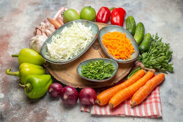 Free photo front view fresh vegetables composition sliced and whole vegetables on white background color ripe healthy life diet salad