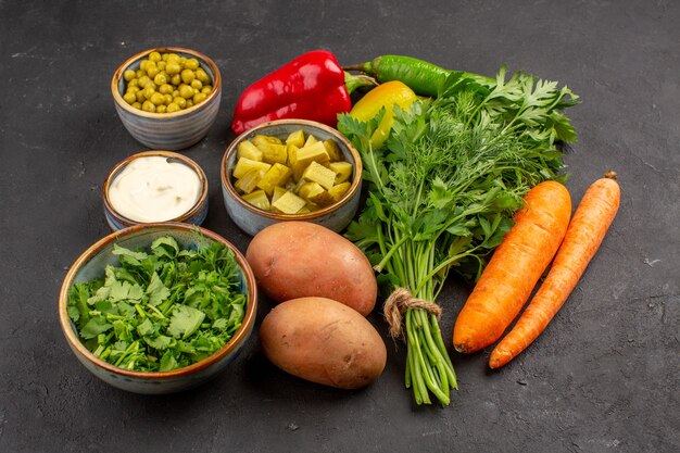 Front view of fresh vegetables with greens on a dark surface