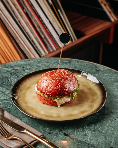 A front view fried burger with fresh vegetables and meat inside round plate