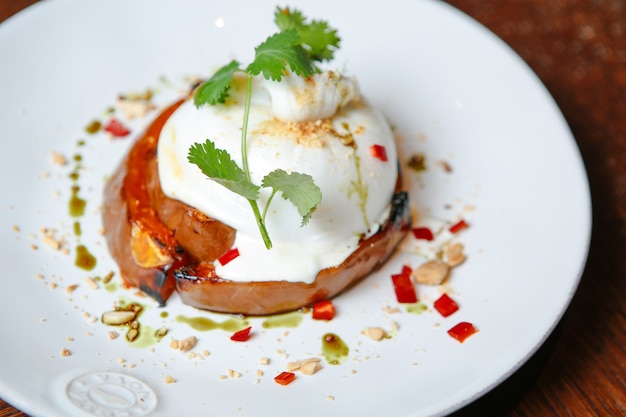 Front view fried chicken breast with sour cream and herbs on a plate