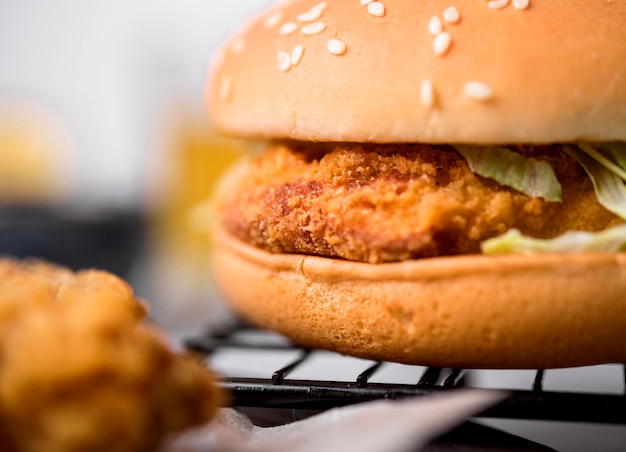 Front view fried chicken burger with salad and sesame seeds