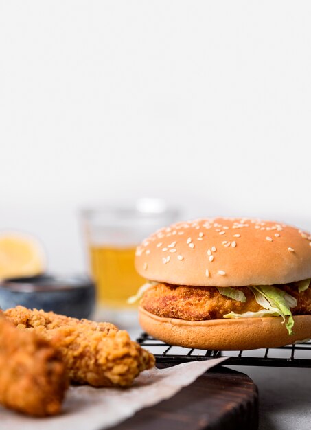 Front view fried chicken pieces and burger