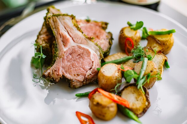 Front view fried ribs with potatoes and herbs