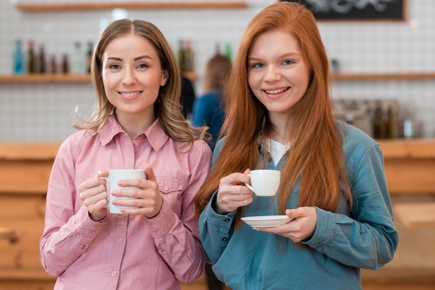 Front view of friends drinking coffee