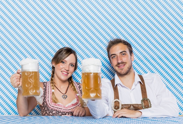 Free photo front view friends holding beer mugs