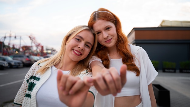 Front view friends making hand gestures