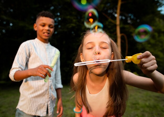 Front view of friends making soap bubbles