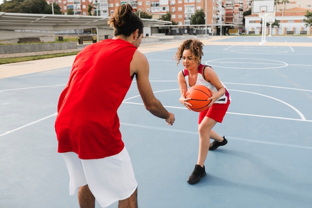 Front view of friends playing basketball