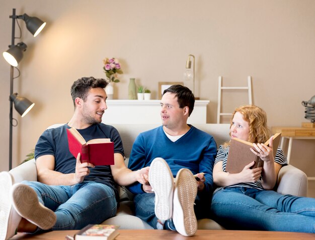 Front view of friends on sofa with books