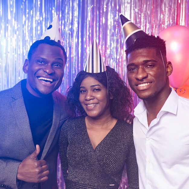 Front view friends wearing party hats