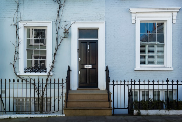 Front view of front door with blue wall and plants